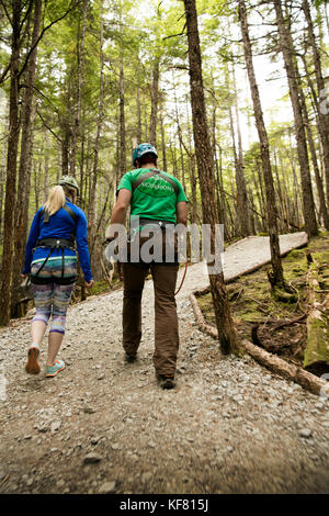 USA Alaska, Sitka, participants prepare for their 4-hour adventure where they will zip past massive spruce, cedars and glacially fed waterfalls, Grizz Stock Photo