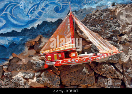 A small colourful decorative yacht part of an elaborate external house wall decoration in El Cotillo, on Fuerteventura, Canary Islands, Spain Stock Photo
