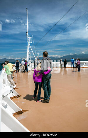 CANADA, Vancouver, British Columbia, one couple enjoys the views off the Holland America Cruise Ship, the Oosterdam, while it navigates the Seymour Na Stock Photo