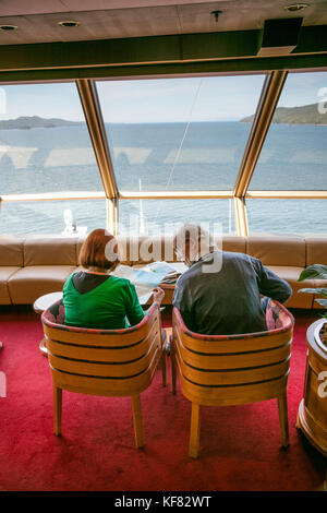 CANADA, Vancouver, British Columbia, passangers sit inside and enjoy the views off the Holland America Cruise Ship, the Oosterdam, while it navigates  Stock Photo