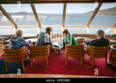 CANADA, Vancouver, British Columbia, passangers sit inside and enjoy the views off the Holland America Cruise Ship, the Oosterdam, while it navigates  Stock Photo