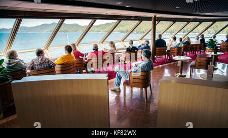 CANADA, Vancouver, British Columbia, passangers sit inside and enjoy the views off the Holland America Cruise Ship, the Oosterdam, while it navigates  Stock Photo