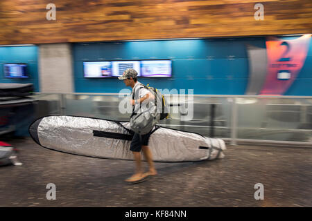 USA, HAWAII, Maui, Jaws, big wave surfer Mike Pietsch in transit from Honolulu to Maui to surf Peahi on the Northshore Stock Photo