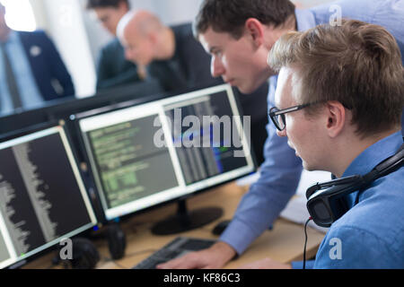 Startup business, software developer working on desktop computer. Stock Photo