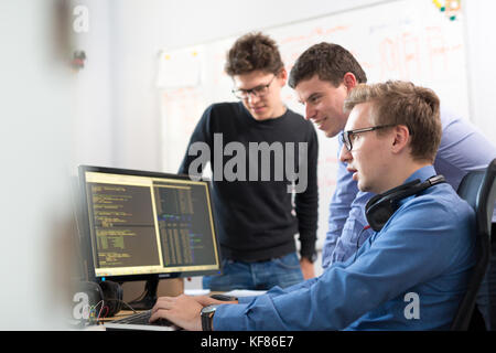 Startup business, software developer working on desktop computer. Stock Photo