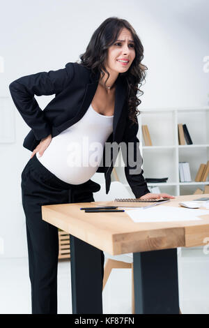 pregnant businesswoman with back pain Stock Photo