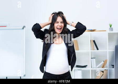 pregnant businesswoman screaming Stock Photo