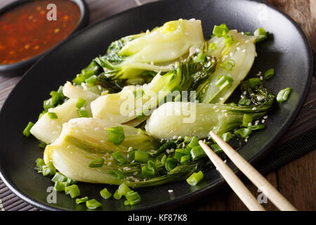 Chinese food: fried bok choy with sesame close-up on a plate. horizontal Stock Photo