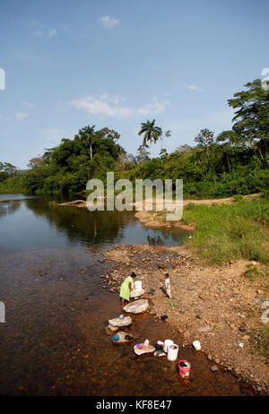 BELIZE, Hopkins, a family washes laundy in a river near Hopkins Stock Photo