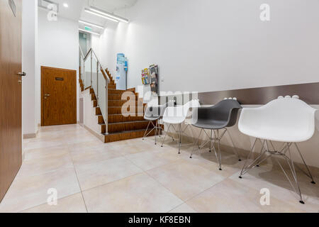 Waiting area in hallway with stairs in dental clinic Stock Photo