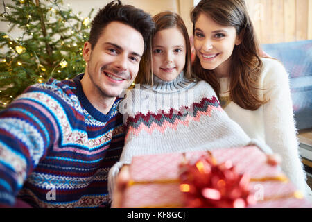 Happy parents and kid with gift box Stock Photo