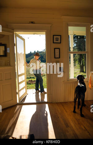 USA, Oregon, Willamette Valley, Clare Carver stands outside her front door at the Big Table Farms Winery, Gaston Stock Photo