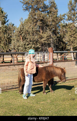 USA, Oregon, Bend, young kids get to pet the farm animals at the annual pumpkin patch located in Terrebone near Smith Rock State Park Stock Photo