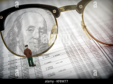 Figure of man separated by glasses, concept of economy Stock Photo