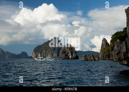 PHILIPPINES, Palawan, El Nido, view of surrounding rock formations and a fishing boat from Lagen Island Resort in Bacuit Bay in the South China Sea Stock Photo