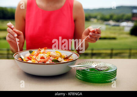 USA, Tennessee, Nashville, Iroquois Steeplechase, young woman serving shrimp Stock Photo