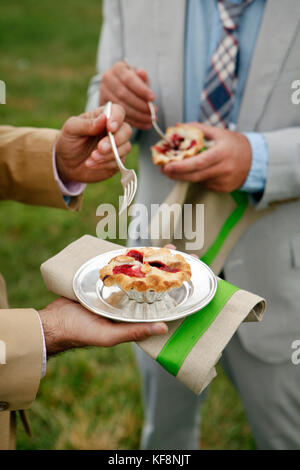 USA, Tennessee, Nashville, Iroquois Steeplechase, eating Mini Berry Pies with lattice crust Stock Photo