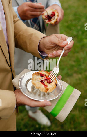 USA, Tennessee, Nashville, Iroquois Steeplechase, eating Mini Berry Pies with lattice crust Stock Photo