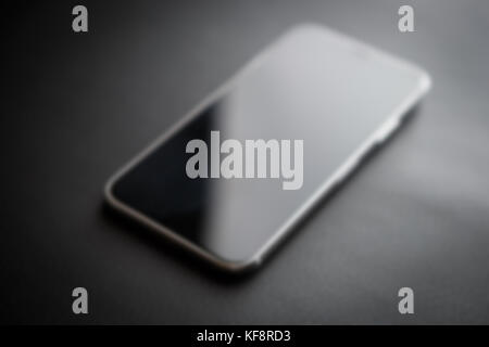 New Iphone X model close up.Modern Iphone 10 smart phone model.Trendy mobile device.White Apple Iphone mobile phone with big screen and dual camera Stock Photo