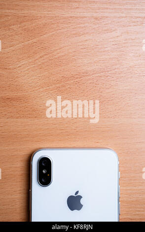 New Iphone X model close up.Modern Iphone 10 smart phone model.Trendy mobile device.White Apple Iphone mobile phone with big screen and dual camera Stock Photo