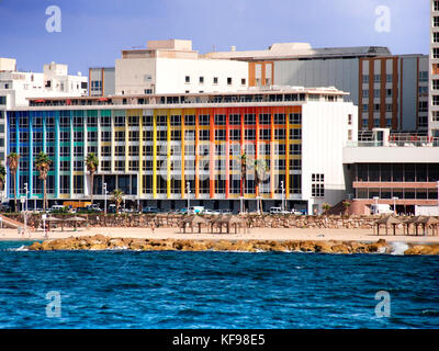 Israel, Tel Aviv coast line and cityscape dominated by the colourful facade of the Dan Hotel by Agam Stock Photo