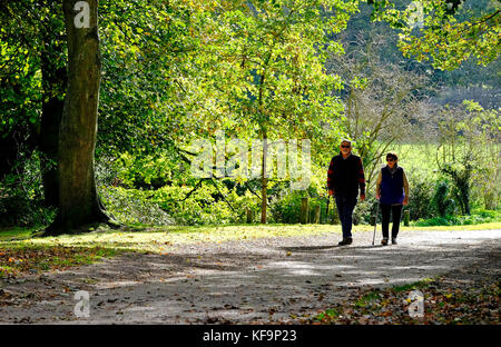 senior couple walking in autumn sunshine, sheringham, north norfolk, england Stock Photo