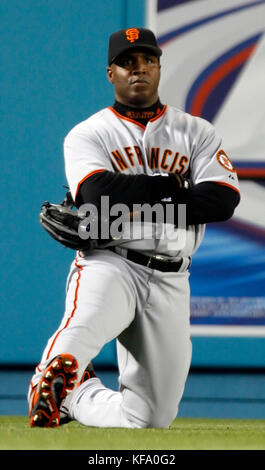 San Francisco Giants' Barry Bonds, foreground, takes some photos with a  camera as photographers record the event before his baseball game against  the Los Angeles Dodgers in Los Angeles on Saturday, April