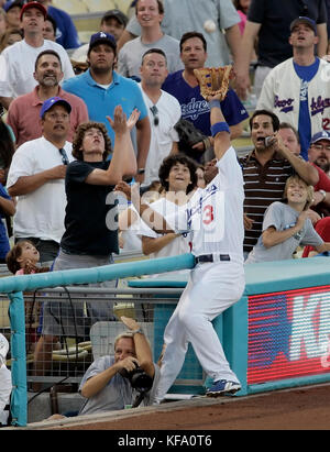 Los Angeles Dodgers third baseman Cesar Izturis slips into the photo well and misses  a foul ball hit by Arizona Diamondbacks' Shawn Green in the second inning of a baseball game in Los Angeles on Monday, July 3, 2006. Photo by Francis Specker Stock Photo