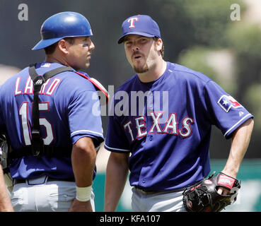 Los Angeles Angels' Garret Anderson, left, is greeted at home by teammate  Vladimir Guerrero after he hit a three-run homer off Texas Rangers pitcher  Adam Eaton in the first inning of a