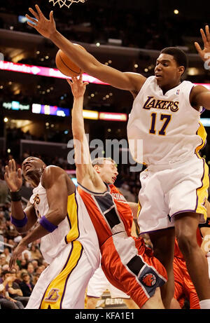 Charlotte Bobcats' Matt Carroll, center, is fouled by Los Angeles Lakers' Andrew Bynum, right, as Lakers' Lamar Odom, left, looks on in the first half in Los Angeles on Sunday Dec. 4, 2005. Photo by Francis Specker Stock Photo