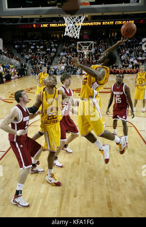 Southern California's O.J. Mayo goes up to the basket with the ball against Washington State's Daven Hermeling, left, Robbie Cowgill  (34) and Kyle Weaver (25), during the first half of a men's college basketball game in Los Angeles on Thursday, Jan. 10, 2008. Photo by Francis Specker Stock Photo