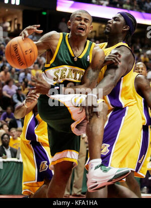 Seattle SuperSonics' Earl Watson, left, is fouled by Los Angeles Lakers' Kwame Brown while going to the basket in the first half of a preseason NBA basketball game in Anaheim, Calif. on Thursday, Oct. 12, 2006. Photo by Francis Specker Stock Photo