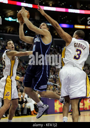 Utah Jazz's Deron Williams, center, shoots over the outstretched arms of Los Angeles Lakers' Devean George, right, and Sasha Vujacic of Slovenia, left,  in the first half in Los Angeles on Sunday, Jan. 1, 2006. Photo by Francis Specker Stock Photo