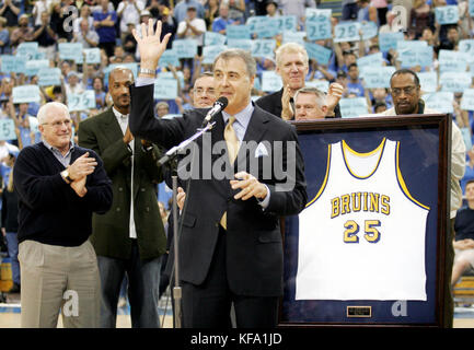 Former UCLA  basketball player Gail Goodrich, foreground, waves to the crowd during a ceremony retiring his number at half-time of the UCLA-Michigan game in Los Angeles on Saturday, Dec. 18, 2004.  Photo by Francis Specker Stock Photo