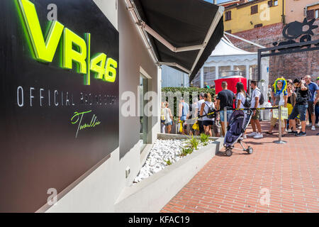 Fans queue at the VR46 merchandise and fan shop. Tavullia, Italy. Hometown of Valentino Rossi. Stock Photo