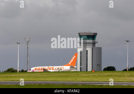 an easyJet Boeing 737-700 parked with the air traffic control-tower behind Stock Photo