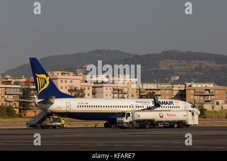 a Ryanair Boeing 737-800 parked on the apron with airstairs and a Total refuelling truck Stock Photo