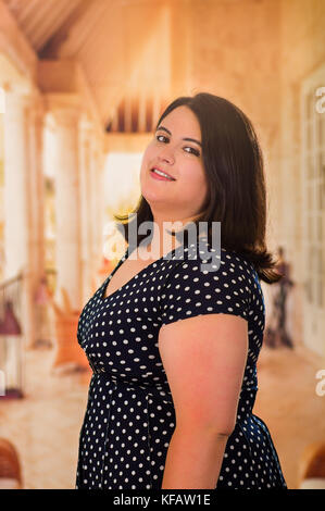 Close up of young beautiful plus size model in black dress, xxl woman in  blurred studio background Stock Photo - Alamy
