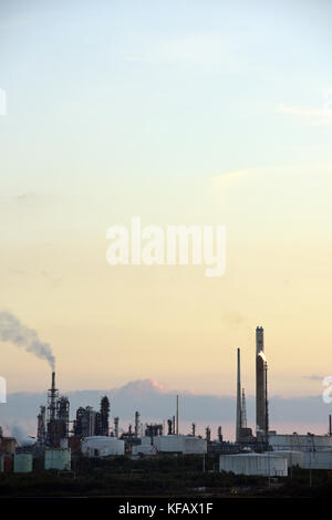 sunset over the exon mobil or esso oil refinery at Fawley on the edge of the new forest and Southampton water in Hampshire , uk. Stock Photo