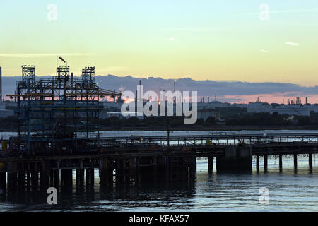 sunset over the exon mobil or esso oil refinery at Fawley on the edge of the new forest and Southampton water in Hampshire , uk. Stock Photo