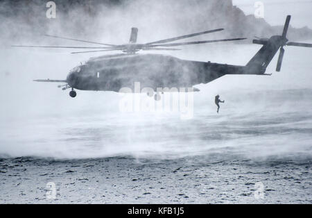 U.S. and South Korean Navy sailors jump out of a U.S. Navy MH-53E Sea Dragon helicopter into the ocean during the Multinational Mine Warfare Exercise October 19, 2017 in Busan, Republic of Korea.    (photo by William Carlisle via Planetpix) Stock Photo