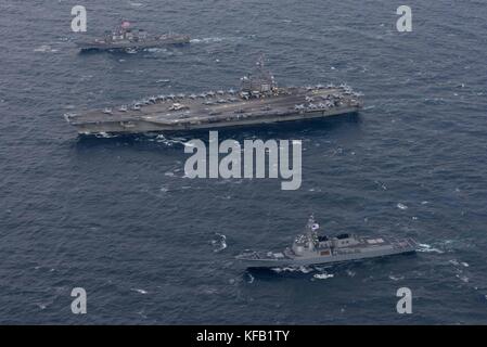 The U.S. Navy Arleigh Burke-class guided-missile destroyer USS Stethem (left), U.S. Navy Nimitz-class aircraft carrier USS Ronald Reagan, and the South Korean Navy Sejong the Great-class guided-missile destroyer ROKS Sejong the Great steam in formation October 18, 2017 in the Sea of Japan.   (photo by Kenneth Abbate via Planetpix) Stock Photo