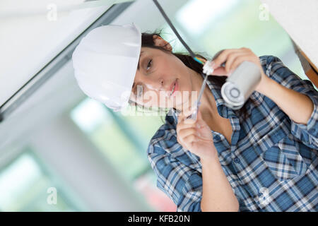 pretty female cctv installing cctv Stock Photo