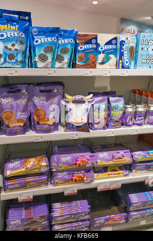 SKOFIJE, SLOVENIA - SEPTEMBER 21, 2017: Milka and Oreo chocolate store shelf in Travel Free bordershop. It is a highway retail outlet on the border be Stock Photo
