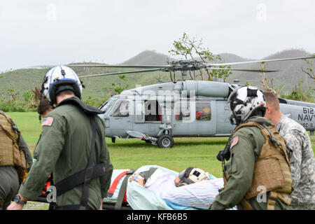 U.S. soldiers transport injured Puerto Rican residents from the 14th Combat Support Hospital during relief efforts in the aftermath of Hurricane Maria October 18, 2017 in Humacao, Puerto Rico.   (photo by Christopher Merian via Planetpix) Stock Photo