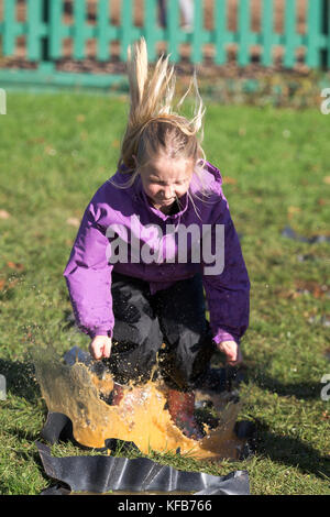 The World Puddle Jumping Championships at Wicksteed Park in Northamptonshire on Wednesday October 25th.  Youngsters have been making a splash at the World Puddle Jumping Championships at Wicksteed Park in Northamptonshire today (Wed).  Competitors battled it out to make the biggest splash at the fifth annual contest in Kettering.  Organisers created a special series of championship-standard puddles and judges gave scores based on things such as height of jump, enthusiasm, distance of splash and stickability (the amount of mud which clings to each competitor). Stock Photo