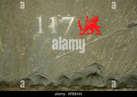 House number 117 etched into slate, with headless Welsh dragon. Stock Photo