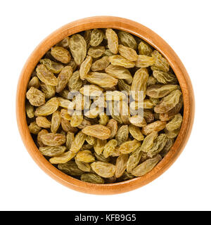 Green raisins in wooden bowl. Dried grapes. Vitis. Green seedless sultana variety from Asia. Eaten raw or used in cooking and baking. Photo. Stock Photo