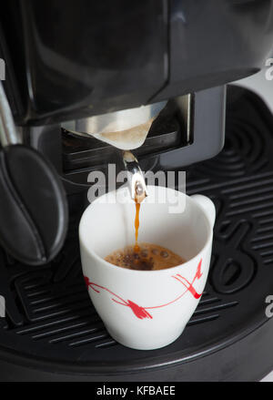 Espresso machine making coffee with paper pod. Stock Photo