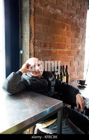 USA, Colorado, Aspen, local man having a cup of coffee at Victoria's Espresso Wine Bar, downtown Aspen Stock Photo